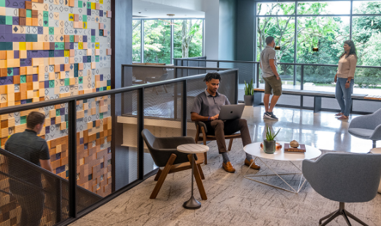 Flex at Chesterbrook's open coworking space filled with people working and talking