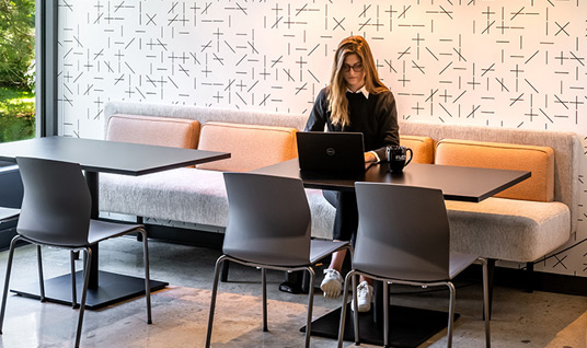 woman working at a booth and table combo in Flex at Chesterbrook
